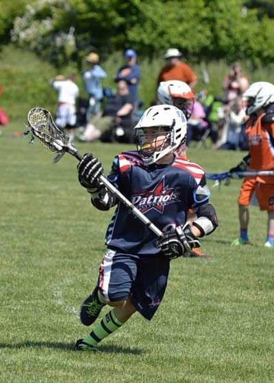 Kid playing LaCrosse